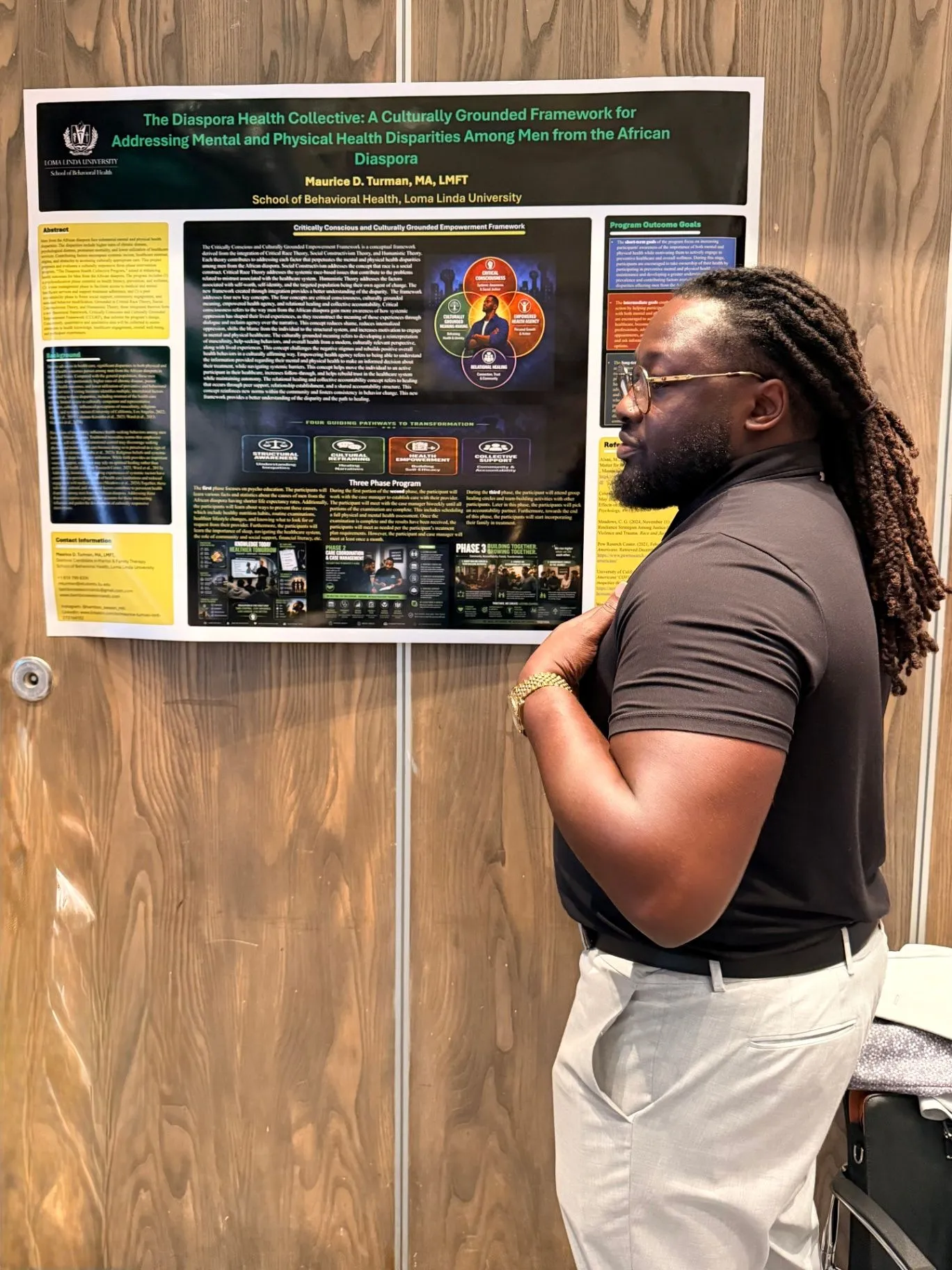 A presenter viewing a research poster about culturally grounded mental and physical health care
